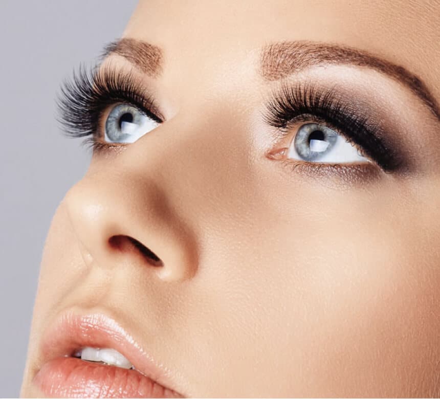 A woman showcasing long eyelashes and expertly applied makeup, highlighting the effects of neurotoxin treatment.