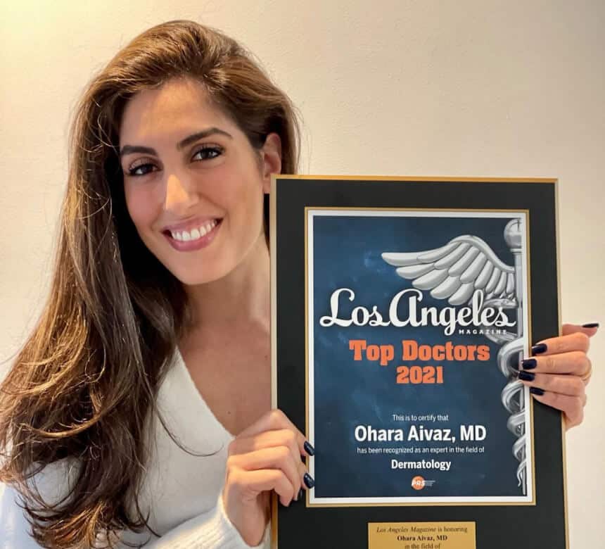 Dr Ohara Aivaz holding certificate of Los Angeles Top Doctors 2021