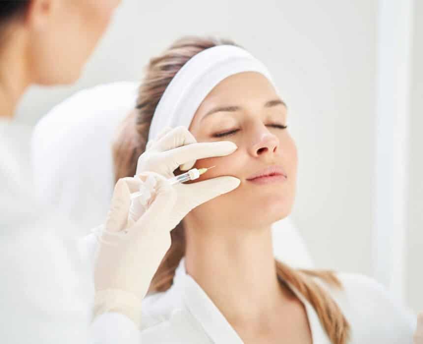 A woman undergoing a facial treatment, highlighting the application of dermal fillers for enhanced beauty and skin rejuvenation.